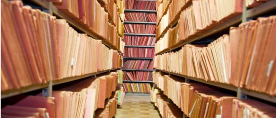old-files-stacked-on-library-shelves-picture-id182902243